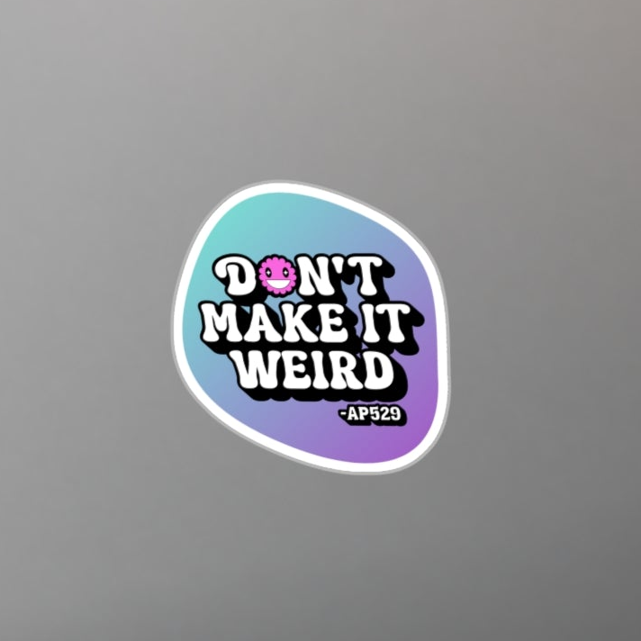 Laptop with a 'Don't Make It Weird' sticker on a desk with a plant and pen.