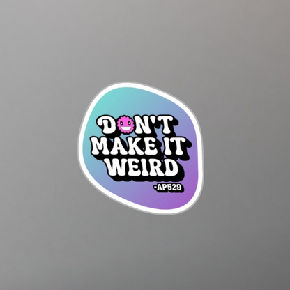 Laptop with a 'Don't Make It Weird' sticker on a desk with a plant and pen.