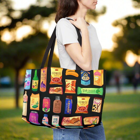 Person carrying a large tote bag with colorful product graphics on a black background