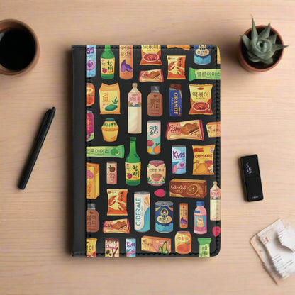 Notebook with colorful product packaging pattern on a black background