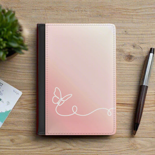 Pink passport holder with a white butterfly design on a white background
