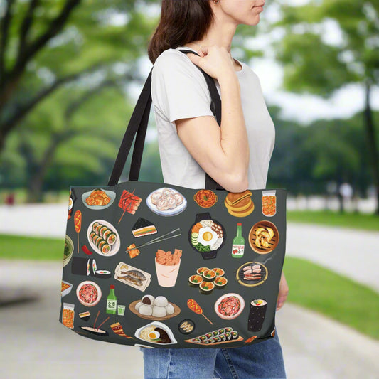 Person carrying a tote bag with food illustrations on a gray background