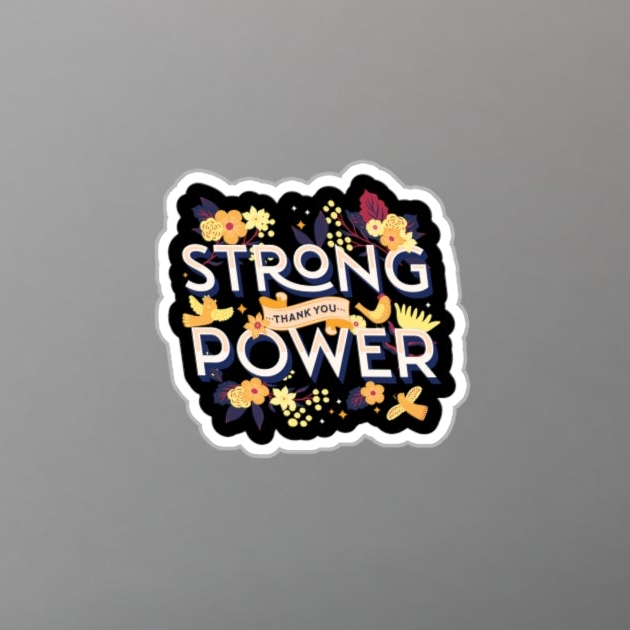 Laptop with a 'Strong is the New Power' sticker on a desk with a plant and pen.