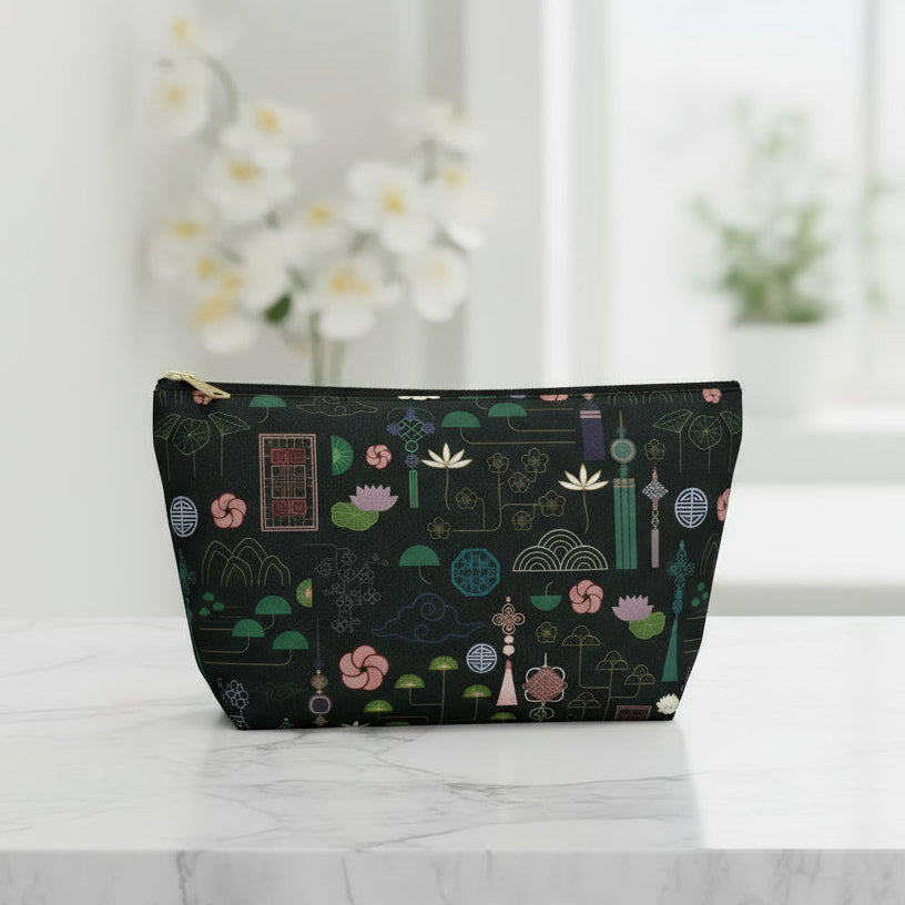 Black pouch with colorful geometric pattern on a white background