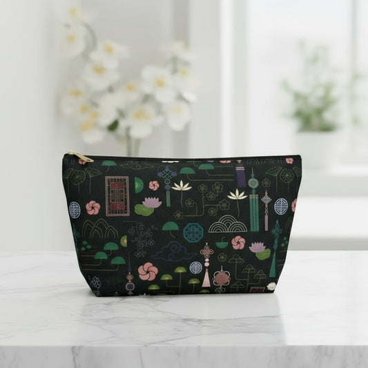 Black pouch with colorful geometric pattern on a white background